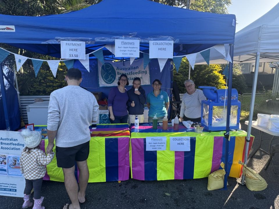 Community stall volunteers serving snow cones